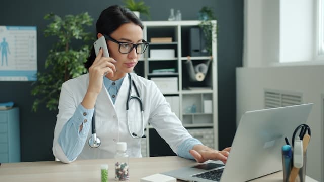 Doctor handling a patient call from a connected medical office
